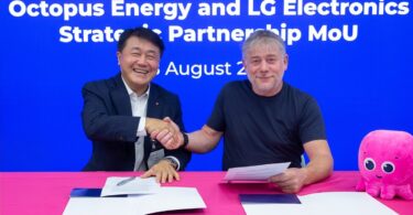 Executives from Octopus Energy and LG Electronics shake hands after signing a strategic partnership agreement.