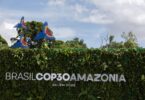 COP30 Amazônia sign surrounded by greenery and tropical foliage in Belém, Brazil, representing global climate and biodiversity action.