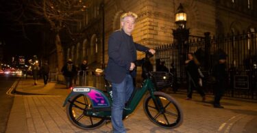 Greg Jackson, Founder and CEO of Octopus Energy, standing with a Forest electric bike outside Number 11 Downing Street in London