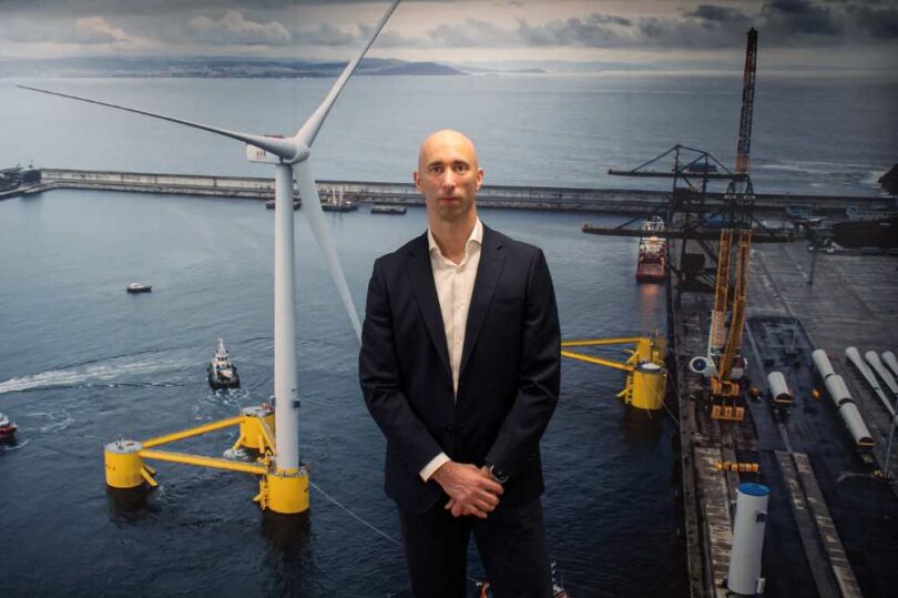João Amaral, new CEO of Principle Power, photographed in front of a floating offshore wind turbine backdrop.