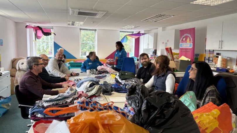 Amazon Filters volunteers sorting donated items at the Just4Kids children’s charity shop during a community volunteering day.