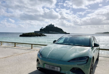 BYD electric car parked by the coast with St Michael’s Mount in the background