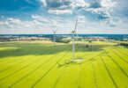 Renewable energy investment strategy illustrated by onshore wind turbines operating across agricultural landscape in Europe