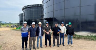 biogas digester tanks at palm oil waste treatment facility in Thailand
