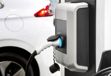 Electric vehicle market share in the UK with EV charging point connected to electric car