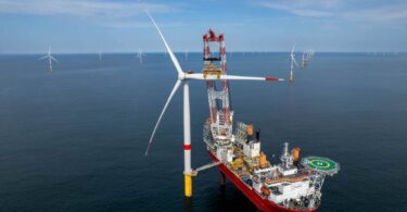 Ocean Winds EMYN offshore wind farm turbine installation vessel at sea with completed wind turbines France
