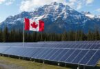 Canadian solar energy installation with national flag and mountain landscape representing clean energy investment