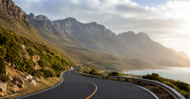 Coastal roadway infrastructure winding through mountainous terrain beside the ocean