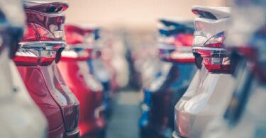 electric vehicle fleet cars parked dealership transport infrastructure