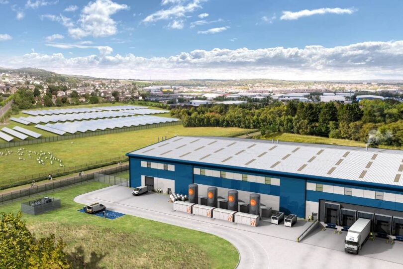 Aerial visualisation of an industrial site showing Caldera thermal-storage heat-battery units beside a warehouse, with an adjacent solar farm