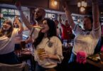 Football fans in a pub watching the World Cup as Octopus Energy offers free electricity to eligible pubs