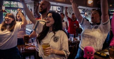Football fans in a pub watching the World Cup as Octopus Energy offers free electricity to eligible pubs