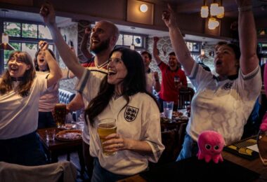 Football fans in a pub watching the World Cup as Octopus Energy offers free electricity to eligible pubs