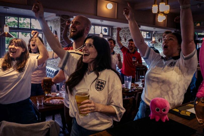 Football fans in a pub watching the World Cup as Octopus Energy offers free electricity to eligible pubs