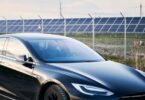 Electric vehicle parked beside a solar-powered charging station, representing the UK's growing transition to zero-emission transport.