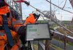 Technician testing CORECHECK technology on an overhead transmission conductor