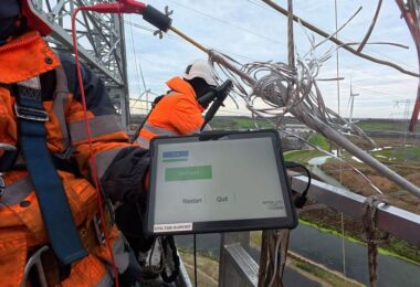 Technician testing CORECHECK technology on an overhead transmission conductor
