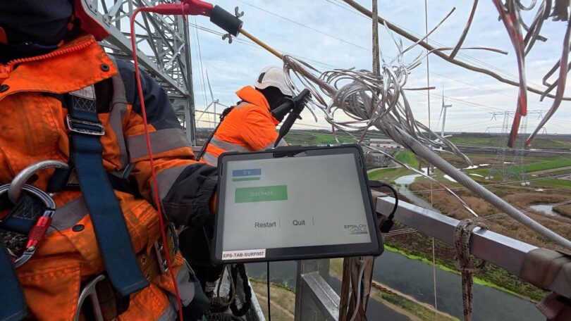 Technician testing CORECHECK technology on an overhead transmission conductor
