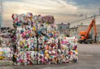 Bales of plastic waste stacked at an industrial recycling facility