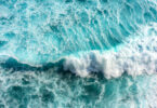 Turquoise and blue sea waves with white foam, as seen in Bali, Indonesia.